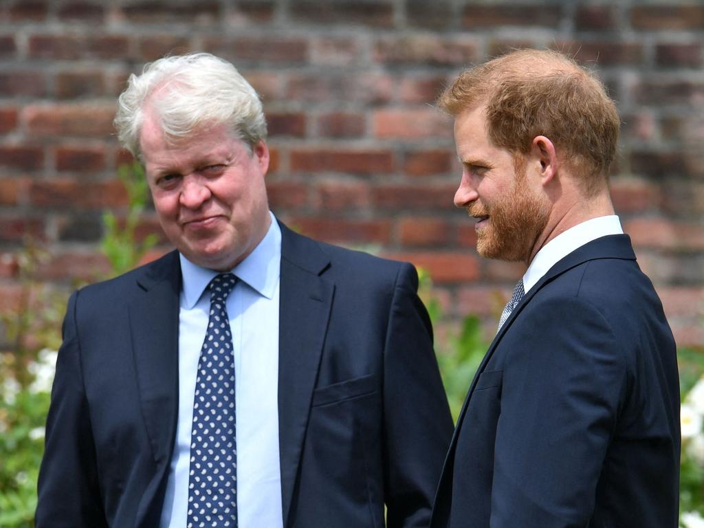 Britain's Prince Harry, Duke of Sussex (R) chats with his uncle Earl Spencer ahead of the unveiling of a statue of their mother, Princess Diana at The Sunken Garden in Kensington Palace.