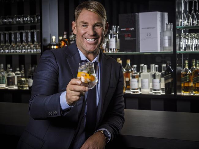 At Home: Shane Warne's slick basement bar is part of what's on offer at his Brighton home, currently on the market. Warne is pictured at home enjoying a SevenZeroEight gin. Picture:  Instagram.