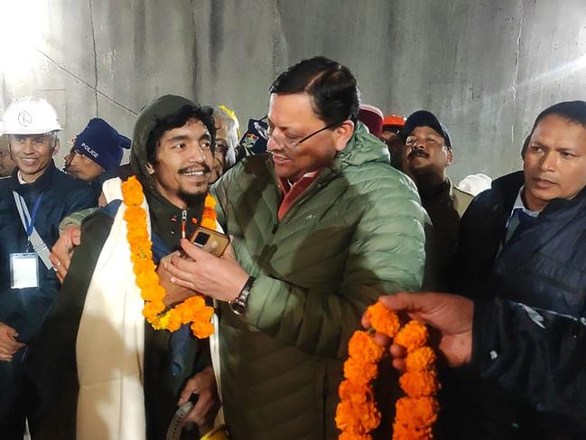 Chief minister of Uttarakhand Pushkar Singh Dhami (R) with a rescue worker. Picture: Department of Information and Public Relation (DIPR) Uttarakhand / AFP