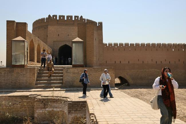 Iraqi students walk through Bab al-Wastani on a walking tour of the historic centre of Baghdad