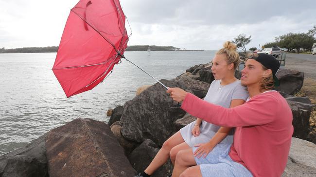 German Back packers Joel Krupka and Alina Weiss in windy wet weather on the Gold Coast. Picture: Mike Batterham.