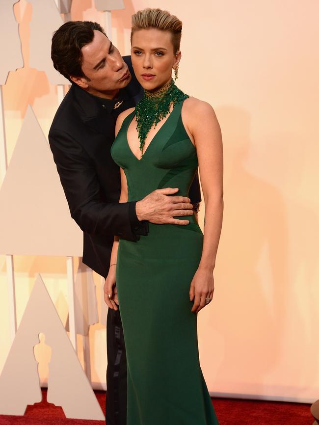 Travolta goes in for the smooch.