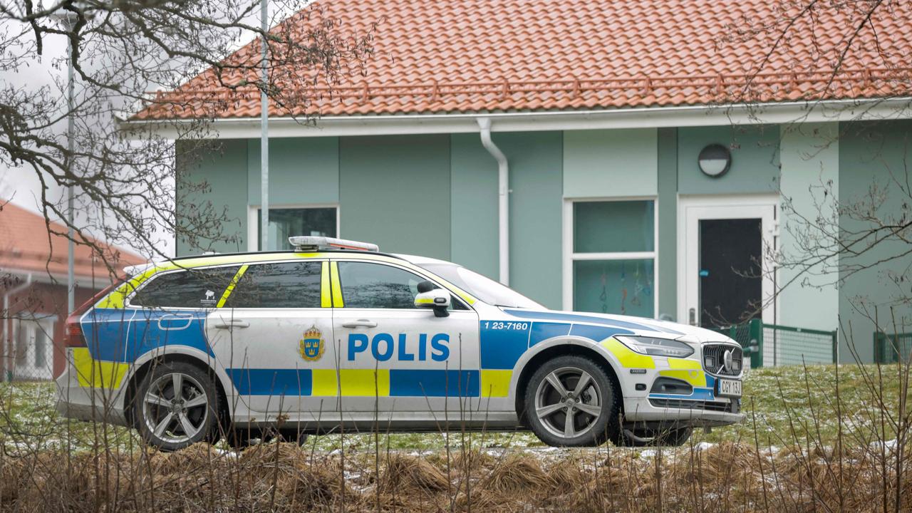 A police vehicle is seen near the Risbergska School building in Orebro, Sweden. (Photo by Kicki NILSSON / TT NEWS AGENCY / AFP) / Sweden OUT