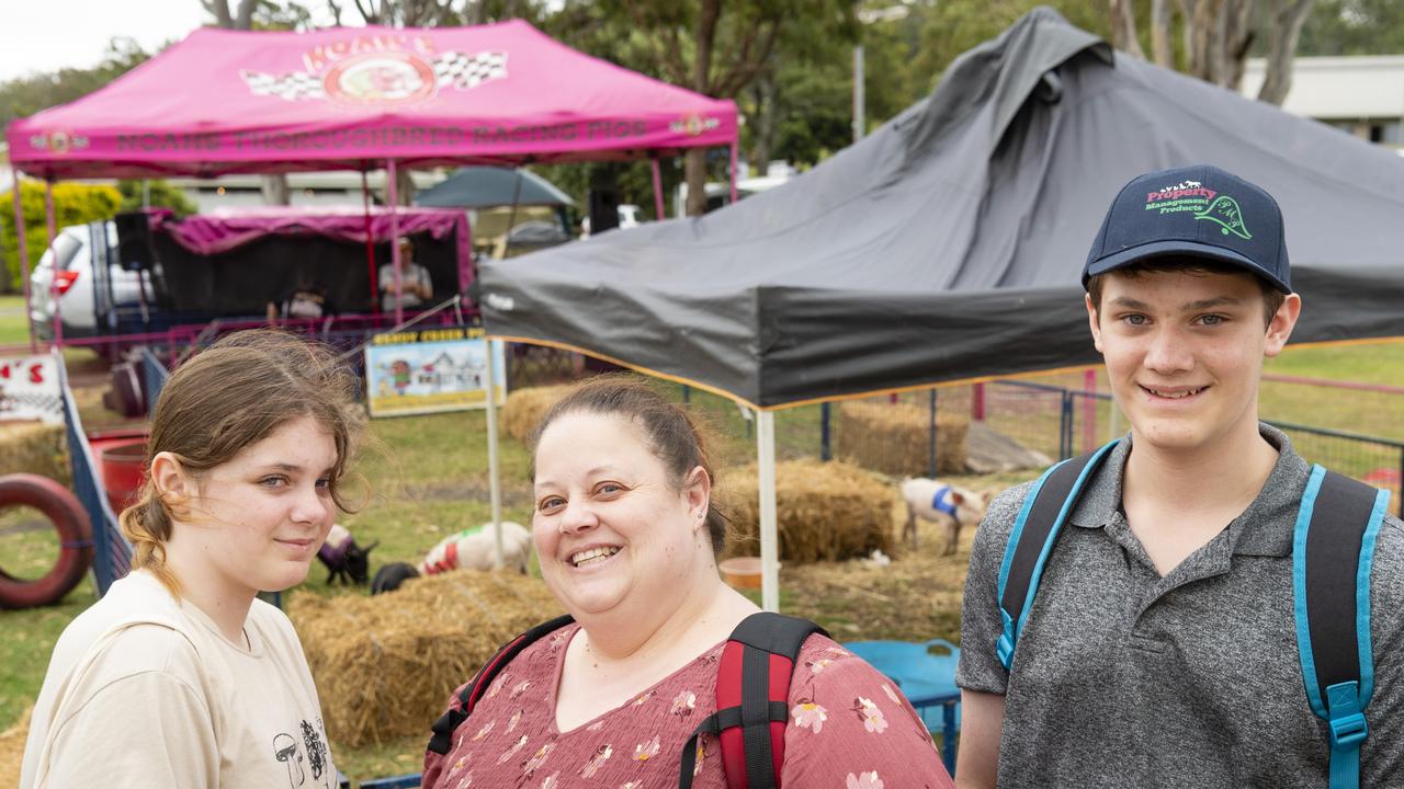 Checking out the racing pigs are (from left) Charlise, Kristy and Brayden Stark at the 2022 Toowoomba Royal Show, Friday, March 25, 2022. Picture: Kevin Farmer