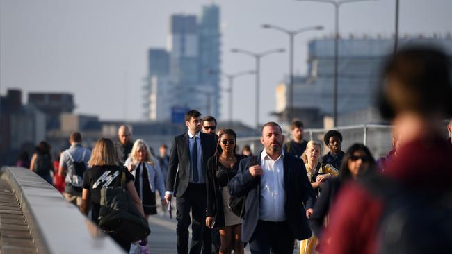 Commuters walk across London Bridge toward the City of London. Picture: AFP.