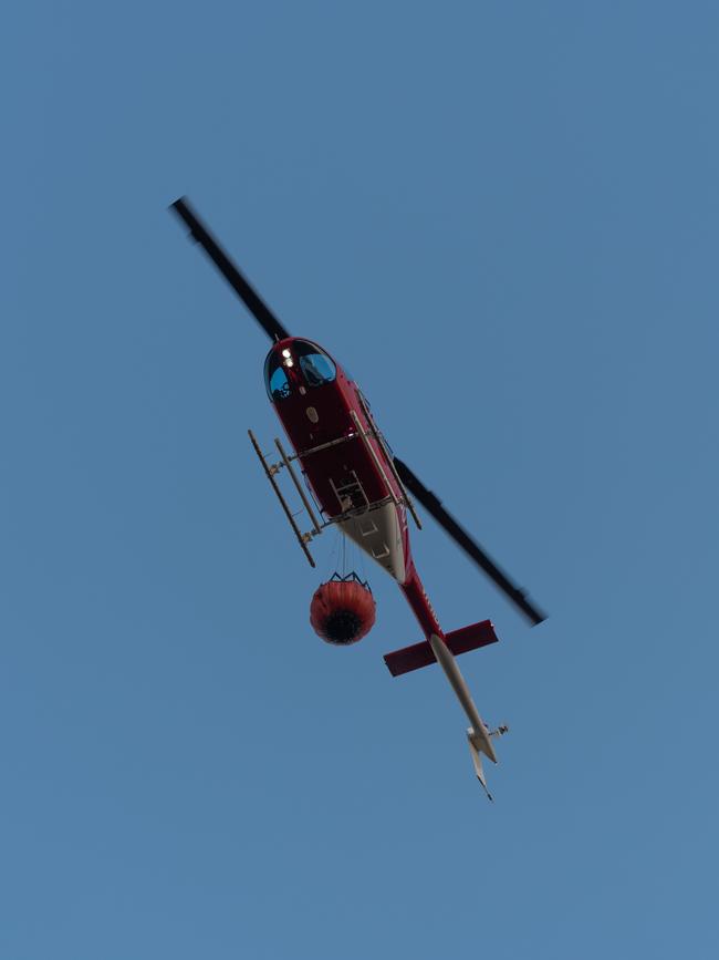 A water bomber at the scene of the blaze in Noonamah. Picture: Che Chorley