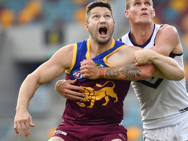 Stefan Martin (left) of the Lions takes on Rory Lobb (right) of the Dockers during the Round 2 AFL match between the Brisbane Lions and the Fremantle Dockers at The Gabba in Brisbane, Saturday, June 13, 2020.  (AAP Image/Darren England) NO ARCHIVING, EDITORIAL USE ONLY