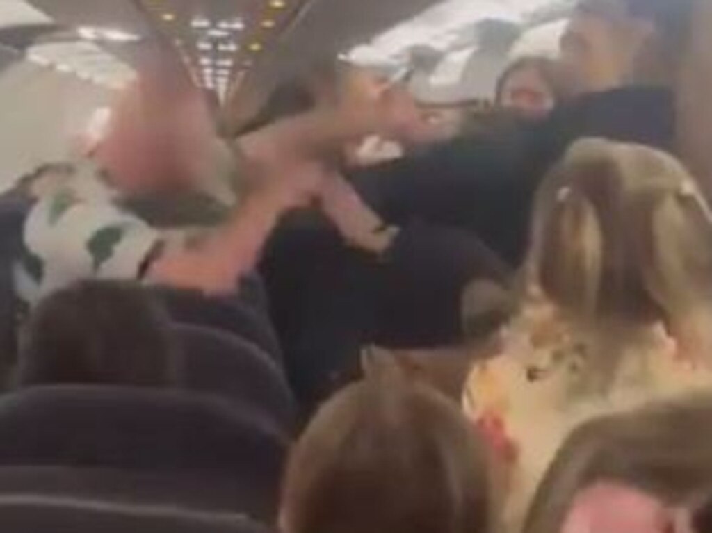 A Celtic Football Club fan was filmed wildly throwing punches at passengers and airline crew as a flight landed in Turkey on Saturday.