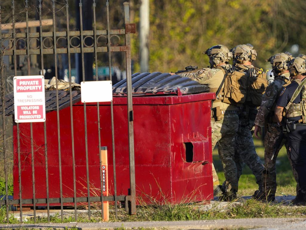 Law enforcement officers approach Jabbar’s house in Houston, Texas. Picture: AP