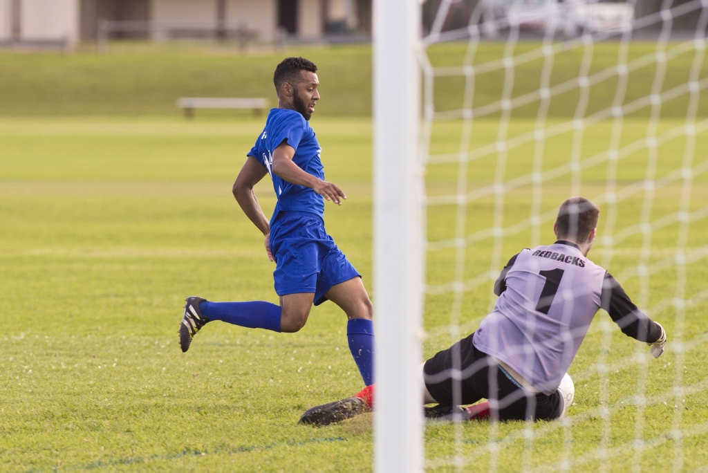 Gatton keeper Daniel Cronin gets to the ball under pressure from Diego Farias of Rockville in Toowoomba Football League Premier Men round six at Captain Cook ovals, Sunday, April 7, 2019. Picture: Kevin Farmer