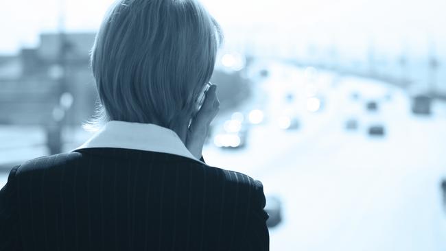 business woman speaks by phone in the street