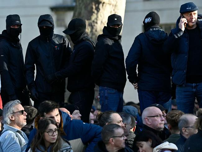 Masked far-right activists during the two-minute silence near the Cenotaph on Whitehall. Picture: AFP