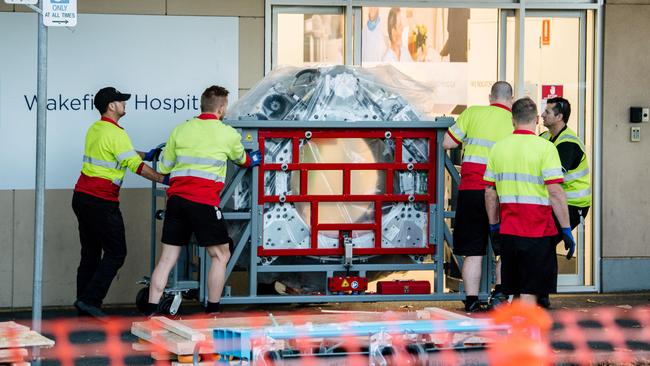 A piece of a CT scanner being taken in to the building where it will be installed at the old Wakefield Hospital today. Picture: AAP Image/ Morgan Sette