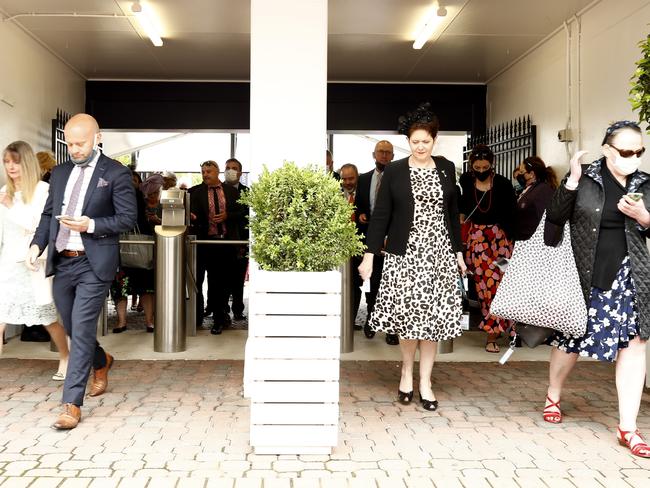 Spectators walk through the gates during 2021 Oaks Day at Flemington Racecourse. Picture: Darrian Traynor