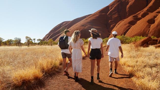 A group of tourists at Uluru. Picture: Tourism NT/Matt Cherubino