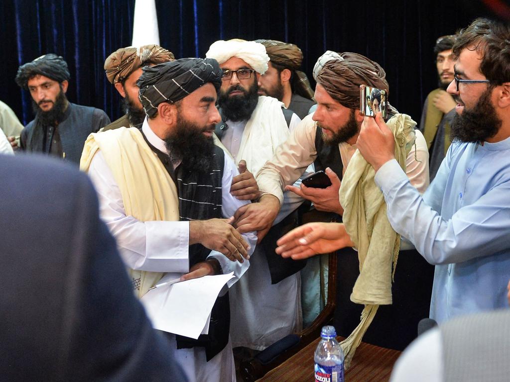 Taliban spokesperson Zabihullah Mujahid, centre, leaves after addressing the first press conference in Kabul on August 17. Picture: AFP