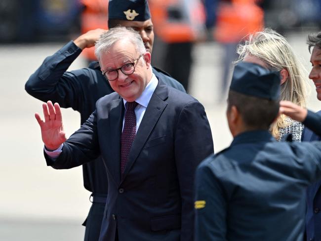 Australia's Prime Minister Anthony Albanese waves upon arrival for the Asia-Pacific Economic Cooperation (APEC) Summit at Air Force Base 8, annexed to the Jorge Chavez International Airport, in Callao, Peru, on November 13, 2024. (Photo by CRIS BOURONCLE / AFP)