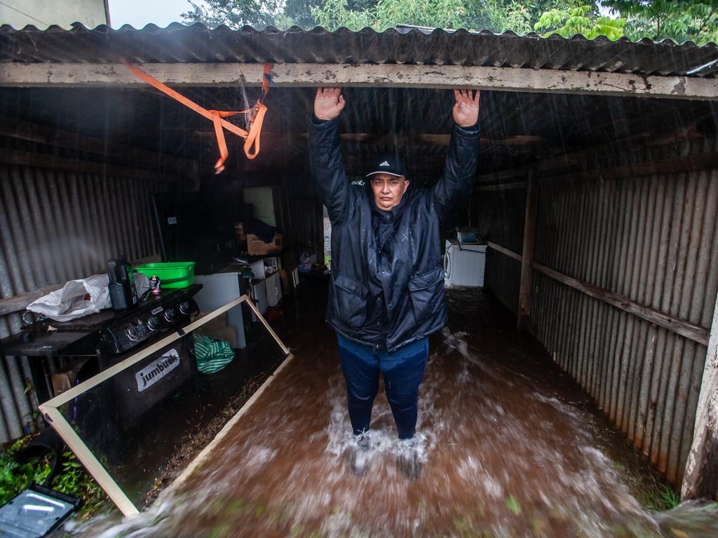 Terina Paul stands in floodwaters in Toowoomba. Picture: David Martinelli