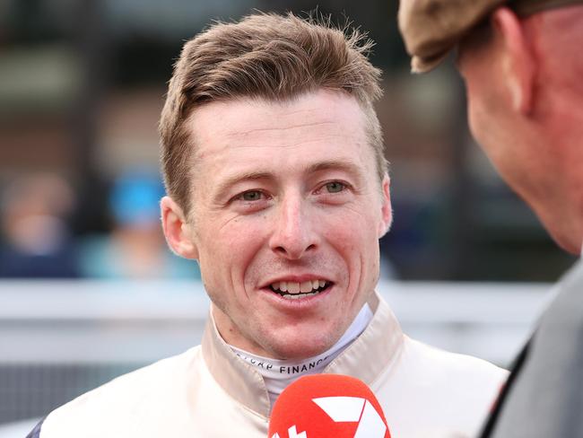 MELBOURNE, AUSTRALIA - OCTOBER 19: Jockey Harry Coffey is interviewed after riding Duke De Sessa to win race 9 the Sportsbet Caulfield Cup during Melbourne Racing at Caulfield Racecourse on October 19, 2024 in Melbourne, Australia. (Photo by Kelly Defina/Getty Images)