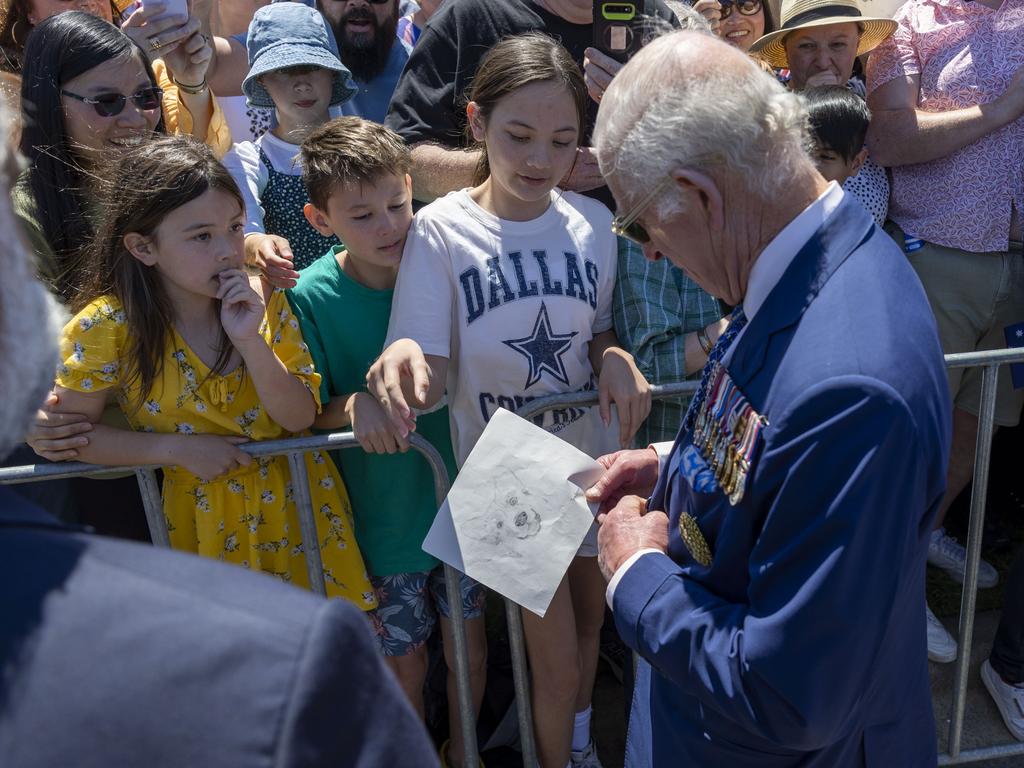 Charles was presented with a corgi drawing by Tori Purser, 12, who had travelled from Merimbula on the NSW South Coast. Picture: Gary Ramage