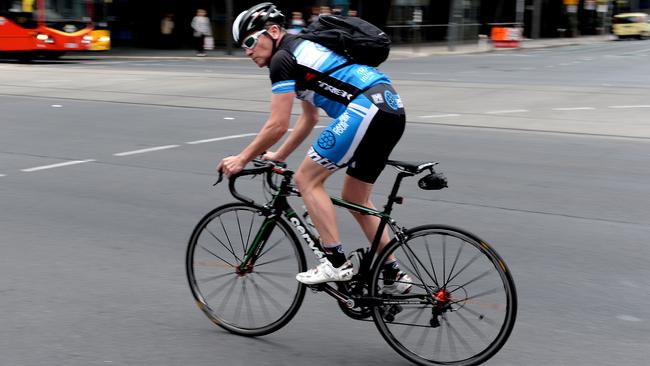 A cyclist riding through Adelaide’s CBD. Picture: Campbell Brodie.