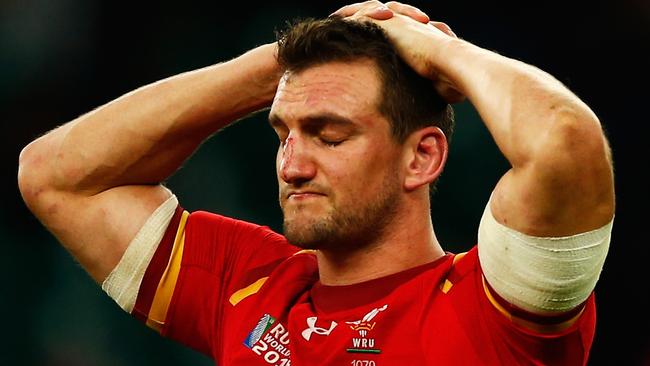 Sam Warburton of Wales holds his head in his hands and looks dejected.