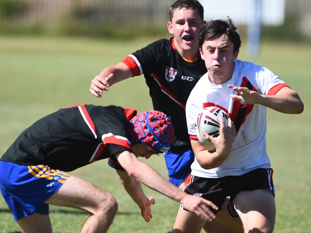 Boys Rugby League State Championship held at Northern Division, Brothers Leagues ground, Townsville. South West (black) v Wide Bay (white). 16-18 years. Ezekiel Monckton of Shalom College.