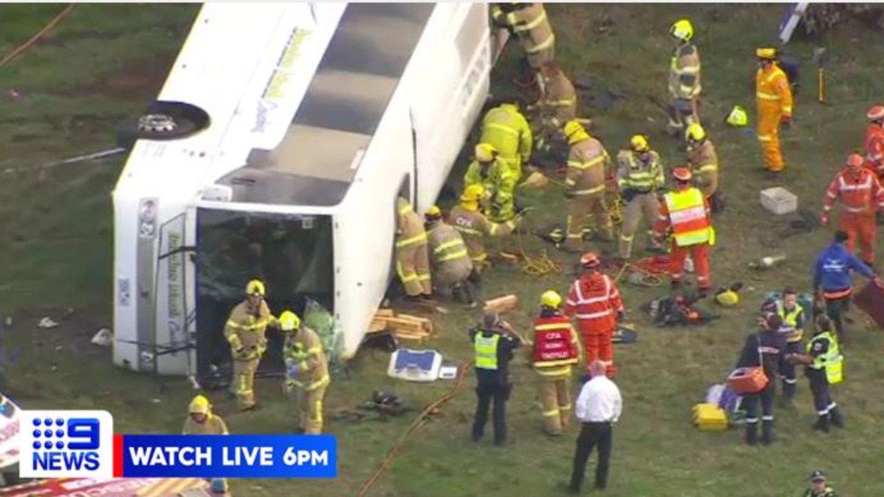 Emergency crews working to rescue children from the bus. Picture: 9 News