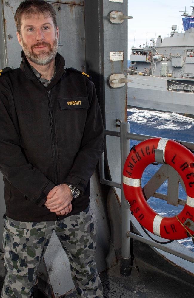 Royal Australian Navy Lieutenant Commander Rob Wright aboard the USS America, with the HMAS Ballarat seen pulling in alongside to refuel. Picture: Mass Communications Specialist 2nd Class Shelby M. Tucker/US Navy