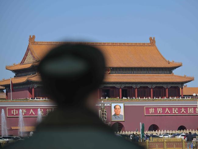 TOPSHOT - A Chinese People's Liberation Army (PLA) soldier stands guard before Tiananmen Gate in Beijing on March 3, 2024, ahead of the country's annual legislative meetings known as the "Two Sessions". (Photo by Pedro Pardo / AFP)