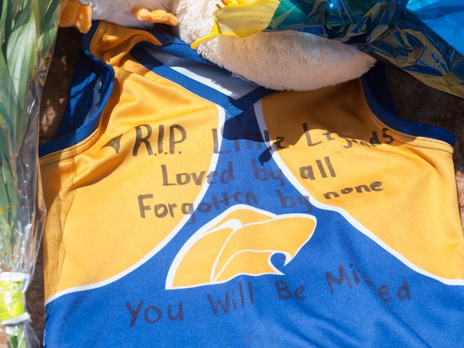 A football jumper left among the cards and flowers as a tribute at the wharf memorial. Photo: Ivon Perrin