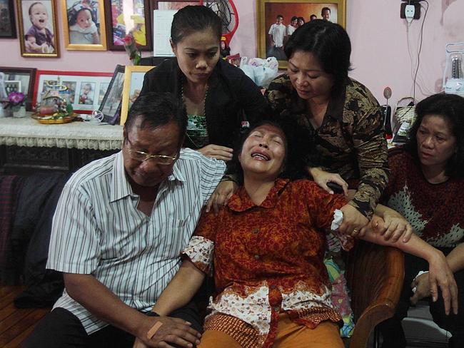 Tearful ... the parents of Firman Chandra Siregar, a 24 year-old passenger of Malaysia Airlines flight 370 that went missing on March 8, at Firman’s family home.