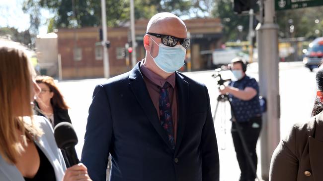 Daniel James Crawford (pictured centre wearing a mask and sun glasses) arrives at his sentencing hearing last year. Picture: NCA NewsWire / Damian Shaw