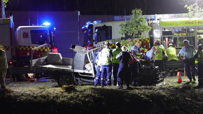 Carnage... Emergency crews surround the crumpled ute. Picture Dean Asher/ TNV