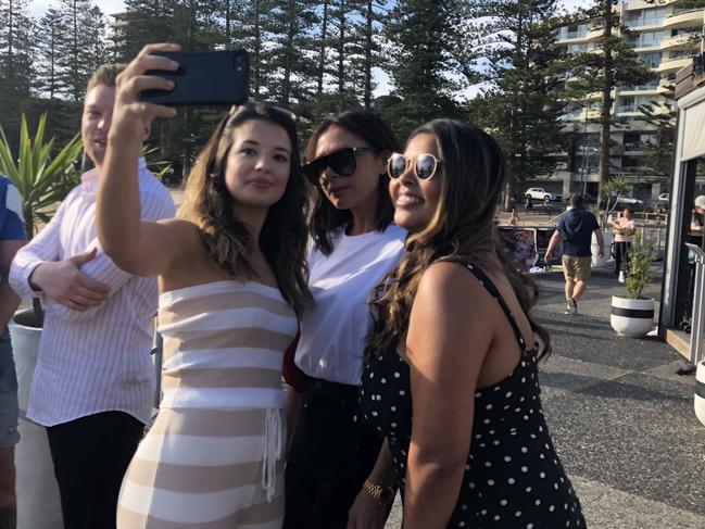 Victoria Beckham took time out to pose for photos with fans in Manly.