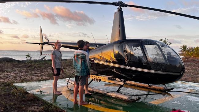 They did not have to be asked twice. Two of the kids awash the helicopter with pilot Elden