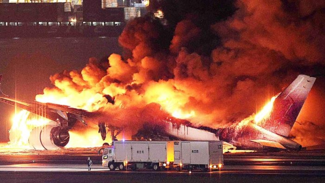 A Japan Airlines plane in flames on the runway of Tokyo's Haneda airport. Picture: JIJI PRESS / AFP