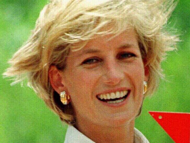 Diana, Princess of Wales, wearing flak jacket holding a landmine during visit to mine field in Huambo, Angola, 15 Jan 1997. land mines landmine landmines british royalty