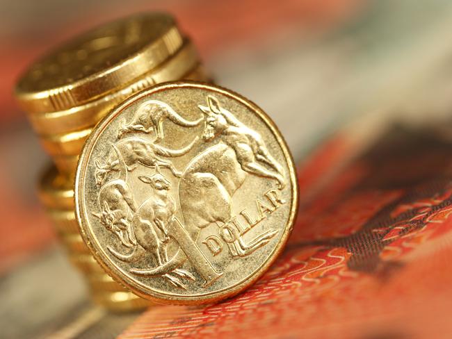 Australian one dollar coin sitting on a twenty dollar note. Shallow depth of field. Picture: istock