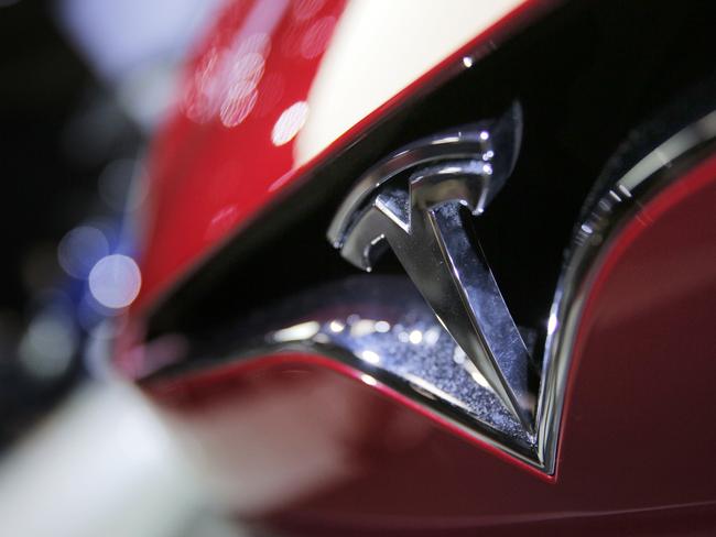 FILE- This Sept. 30, 2016, file photo shows the logo of the Tesla model S at the Paris Auto Show in Paris, France. Shares of Tesla are down 50 percent since September 2019, with concerns about Model 3 demand in the U.S. at the forefront. Daniel Ives of WedBush said in a client note Monday, May 20 that so far there seems to be mixed signals on Model 3 demand, which could make it harder for Tesla to achieve a profit in its third and fourth quarters and the future. (AP Photo/Christophe Ena, File)