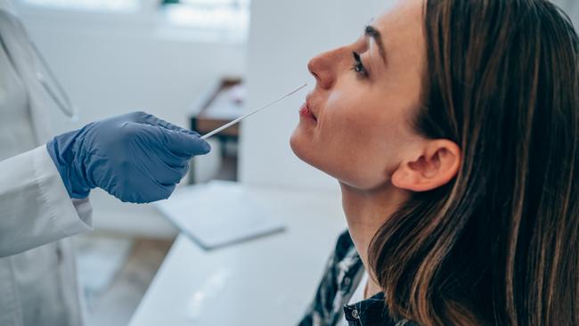 A doctor using cotton swab while doing coronavirus PCR test at a hospital. Jeremy Chatterton, 51, of Manly, was convicted in Manly court of impersonating a doctor at a Covid testing centre while working as a pathology swab collector. Now NSW authorities have banned him from ever offering a health service to the public again. File picture: Getty Images