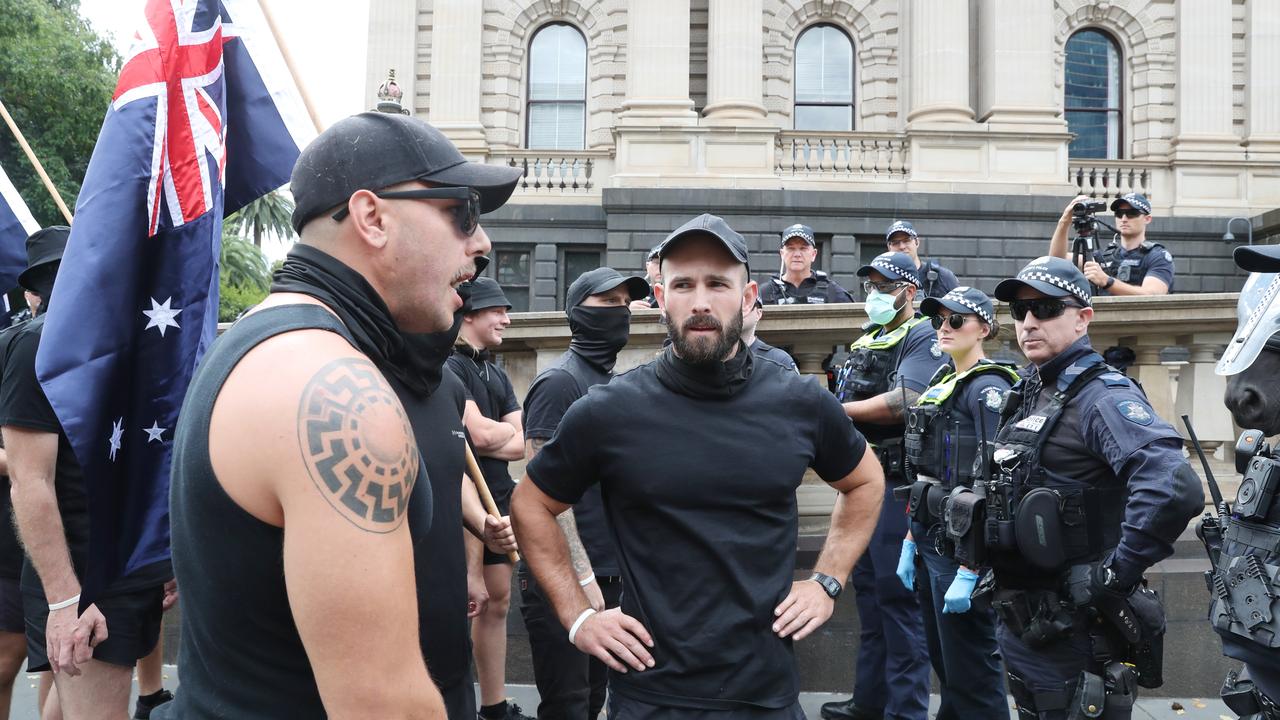 Mr Sewell (centre) and members of the National Socialist Network face off with police in Melbourne. Picture: NewsWire / David Crosling