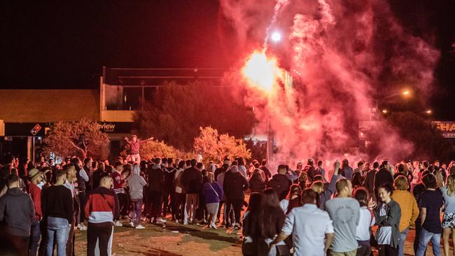 A flare explodes in the air above hundreds of teenagers. Picture: Jason Edwards