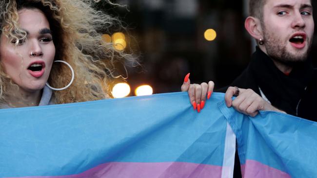 Morgin Dupont, 25 (left,) holds up the flag for Transgender and Gender Noncomforming people at a rally in New York City yesterday. Yana Paskova/Getty Images/AFP