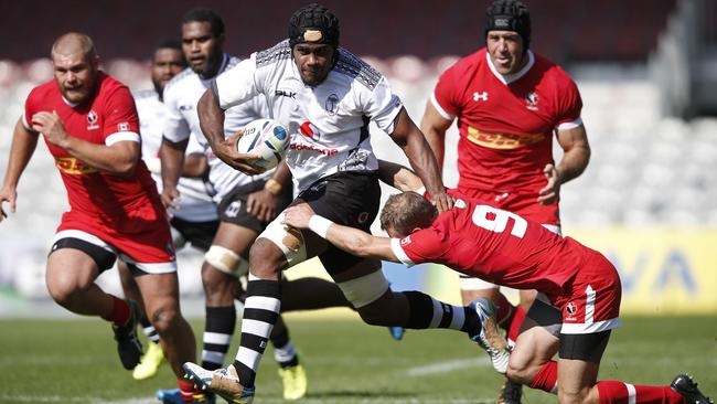 Fiji's flanker Dom Waqaniburotu is tackled by Canada's scrum half Gordon McRorie (R) during the international rugby union friendly match between Canada and Fiji, ahead of the 2015 Rugby World Cup, at The Stoop in Twickenham, west of London, on September 6, 2015. AFP PHOTO / ADRIAN DENNIS