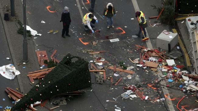 Police officers inspect the crime scene in Berlin, Germany. Picture: AP Photo/Markus Schreiber