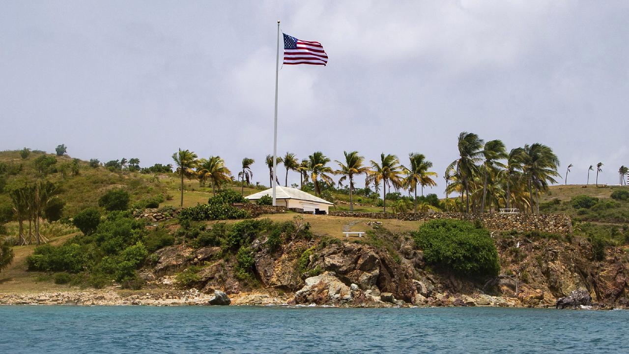 Epstein bought the island more than two decades ago and began to transform it, clearing the native vegetation, ringing the property with towering palm trees and planting two massive US flags on either end. Picture: Gianfranco Gaglione