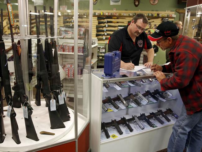 Gun seller Steven King, left, says he sold two to three times more weapons sales than normal as a grand jury decided whether to indict Ferguson police Officer Darren Wilson in the shooting death of Michael Brown. (AP Photo/Jeff Roberson)