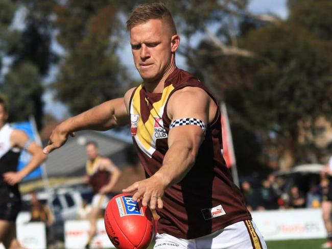 Boronia veteran Matt Buzinskas gets the ball on his boot. Picture Davis Harrigan