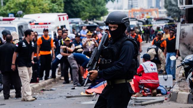 JAKARTA, INDONESIA - JANUARY 14: An Indonesian policeman stands guard in front of a blast site at the Indonesia capital Jakarta on January 14, 2016 in Jakarta, Indonesia. Reports of explosions and gunshots in the centre of the Indonesian capital, including outside the United Nations building and in the front of the Sarinah shopping mall, an area with many luxury hotels, embassies and offices. (Photo by Oscar Siagian/Getty Images)